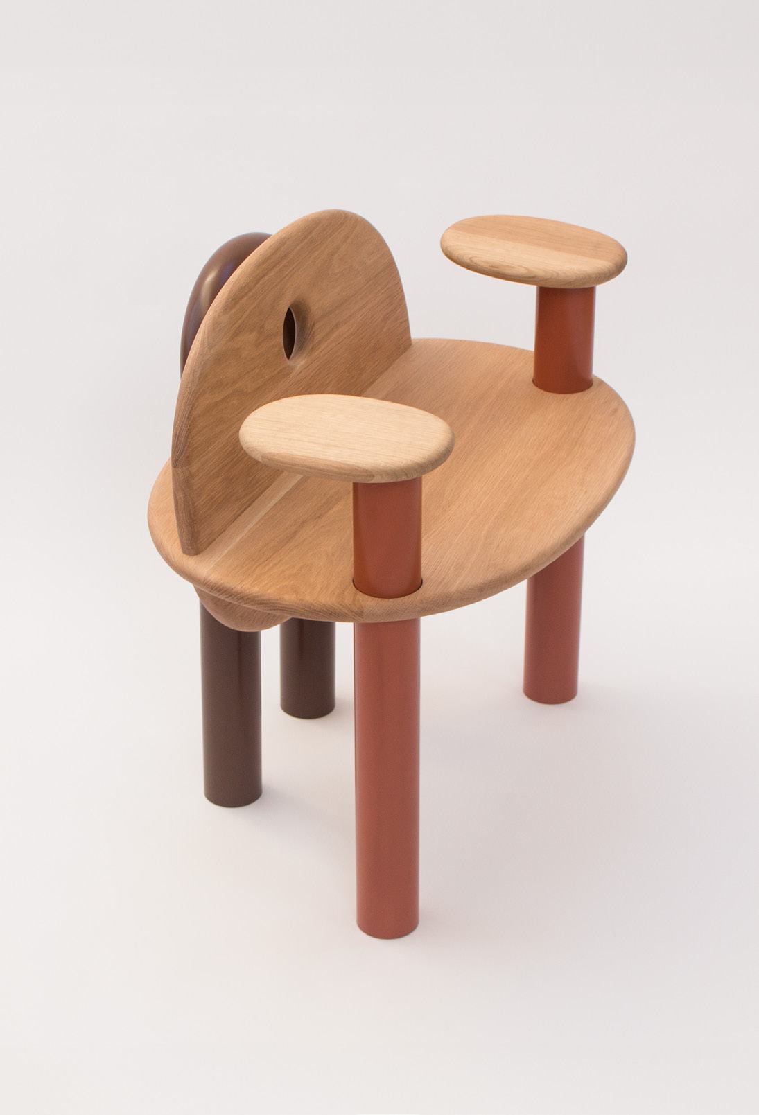 The TOT Chair, oak seat and armrests on rust and brown steel legs
