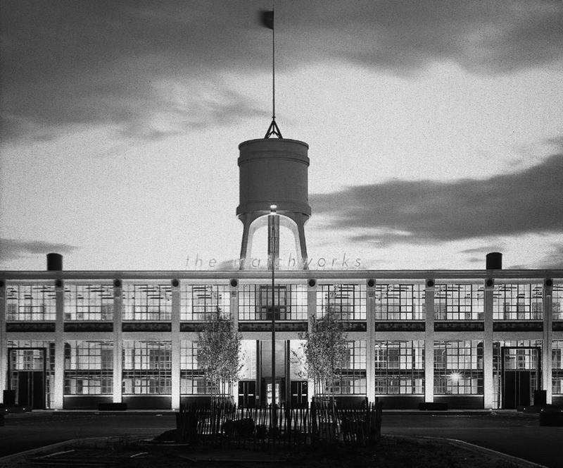 Black and white photograph of the Matchworks building and water tower at dusk