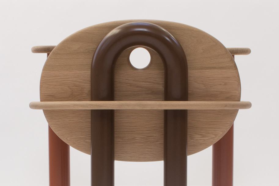 Looped brown back leg rising through the backrest