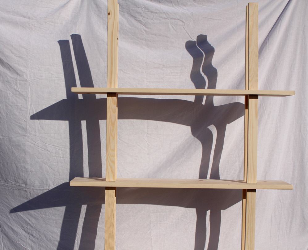 Stack Shelving casting long shadows on a white cloth backdrop