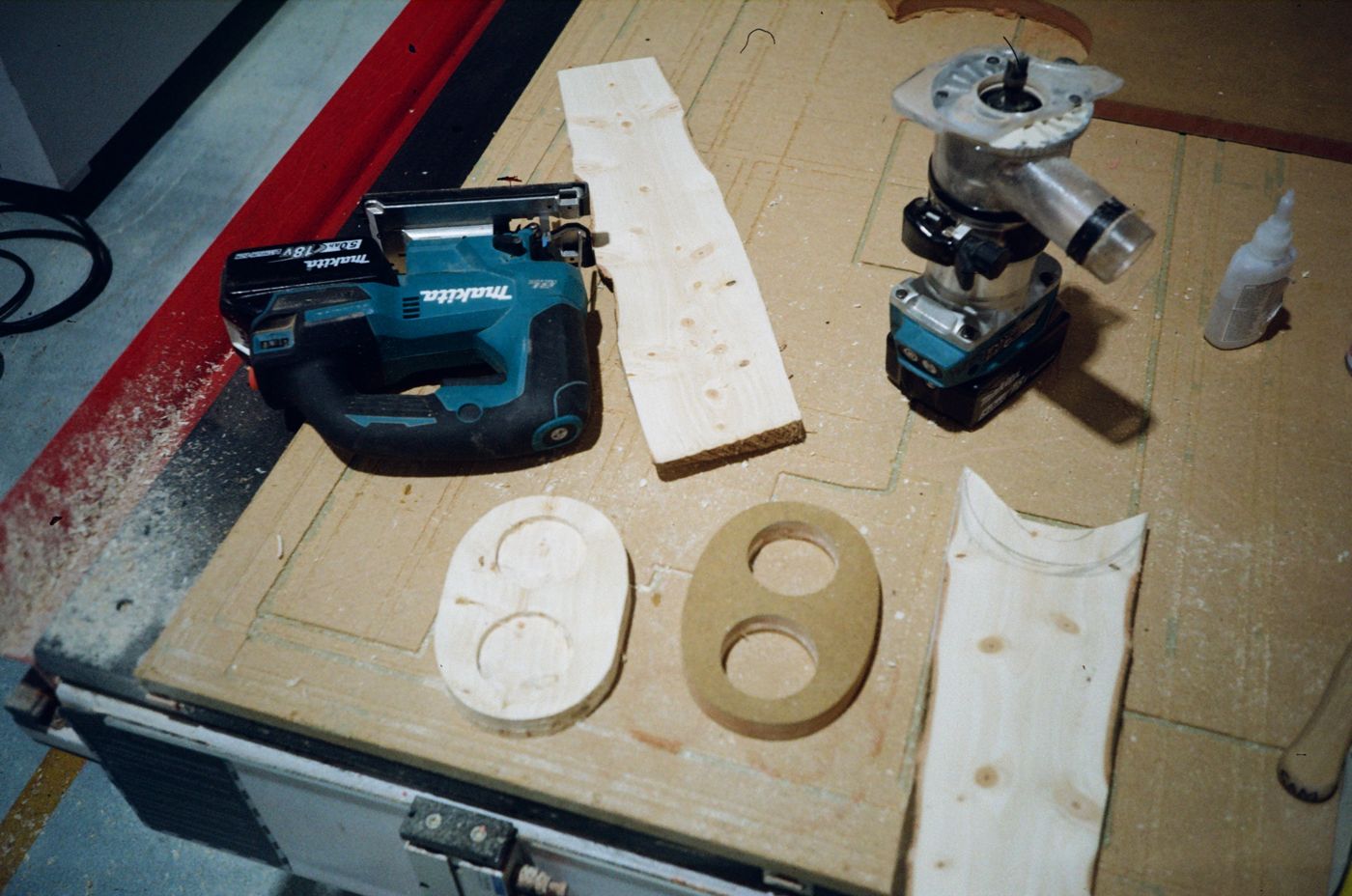 Routed pine top, template and power tools on the bench