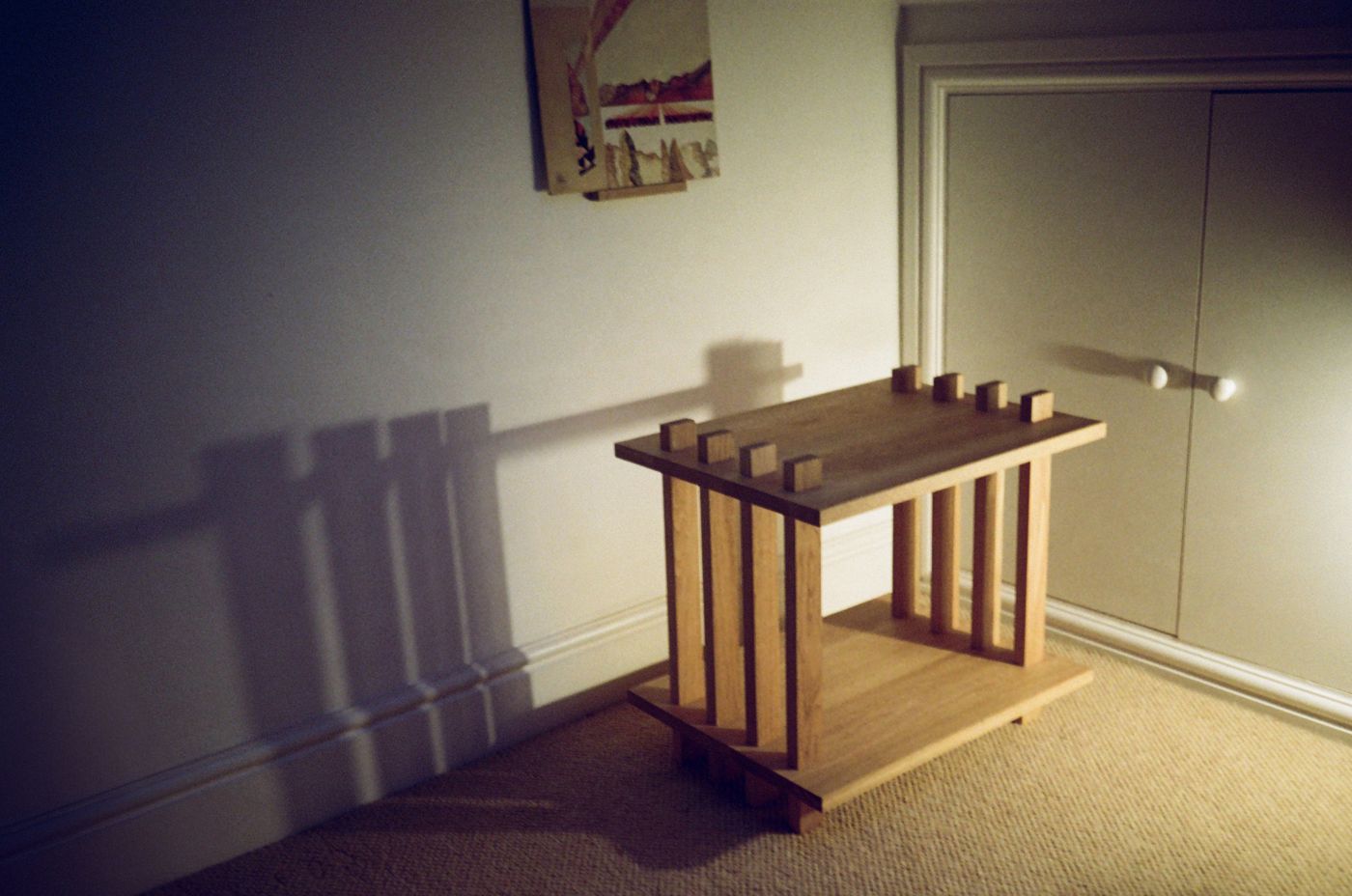 Turntable Table in a bedroom corner, its posts casting long shadows on the wall